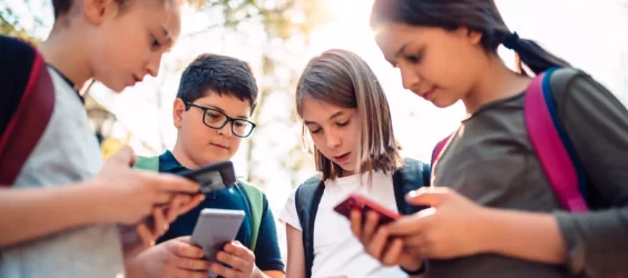 school kids look at their phones