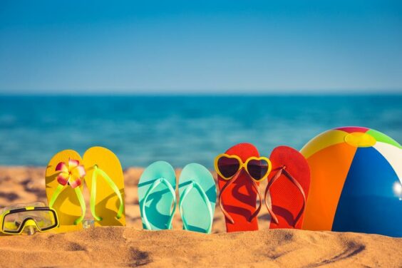 beach photograph of sandals in the sand and a beach ball