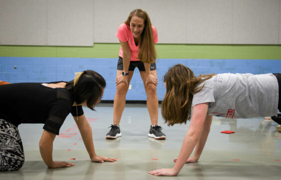 athletic director having two kids do push ups