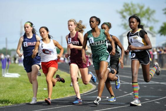 teens running track in highschool